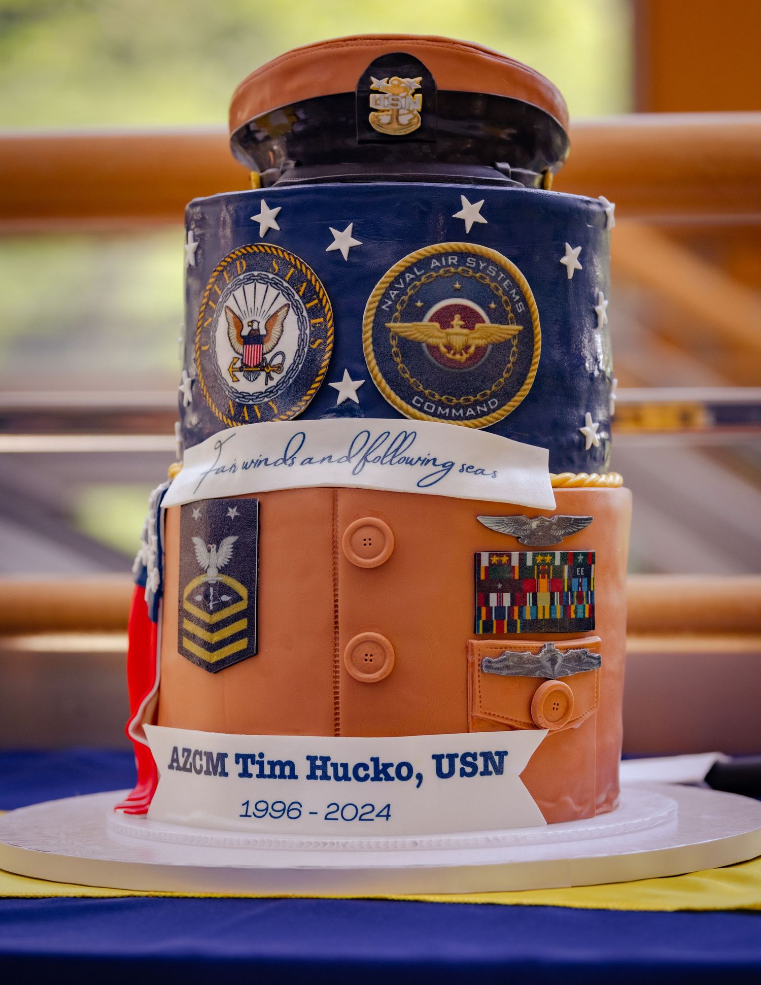 Portcall Productions detail shot capturing a 'Fair Winds and Following Seas' tribute cake celebrating 28 years of naval service.