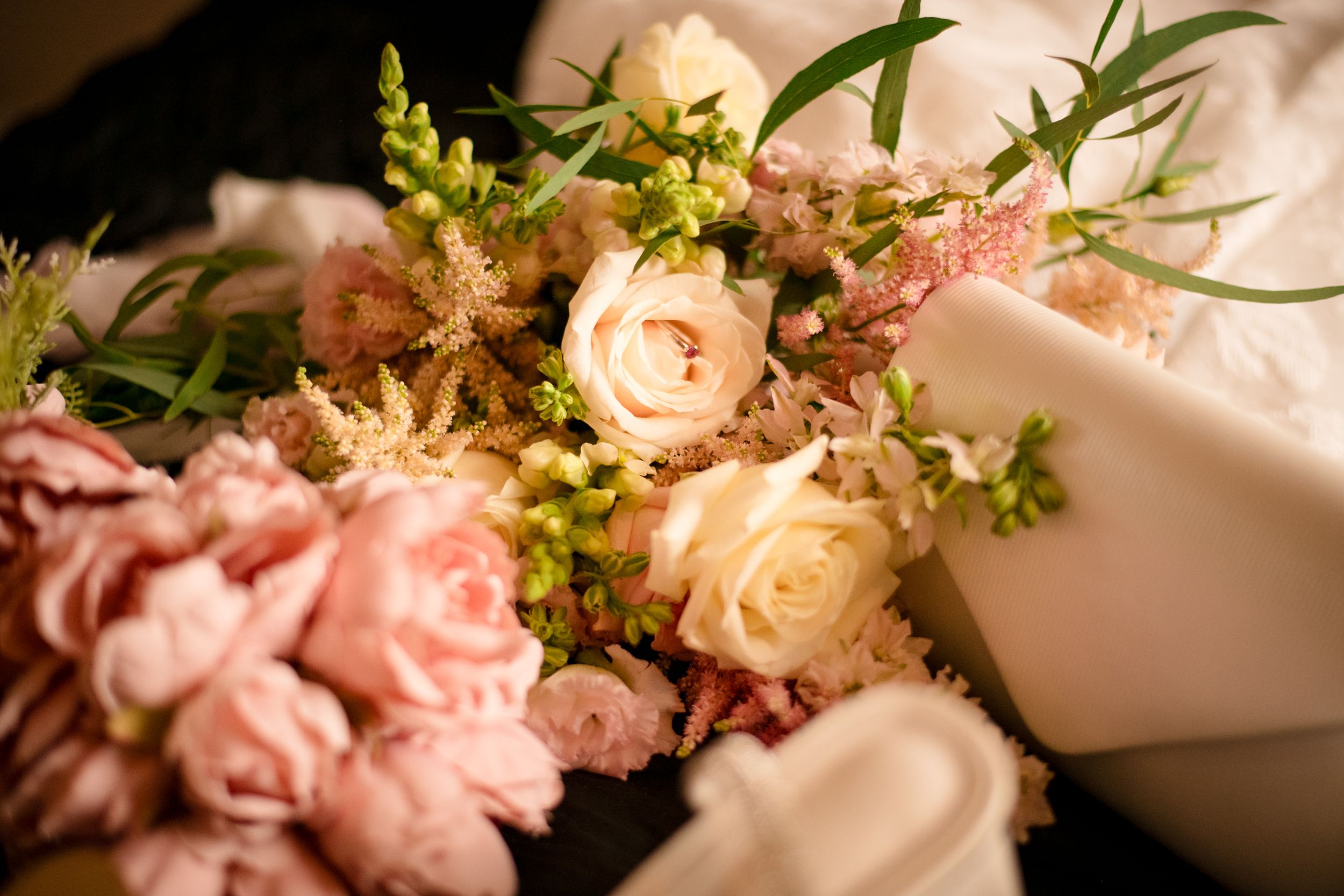 Soft pink and cream roses arranged in an elegant wedding bouquet.