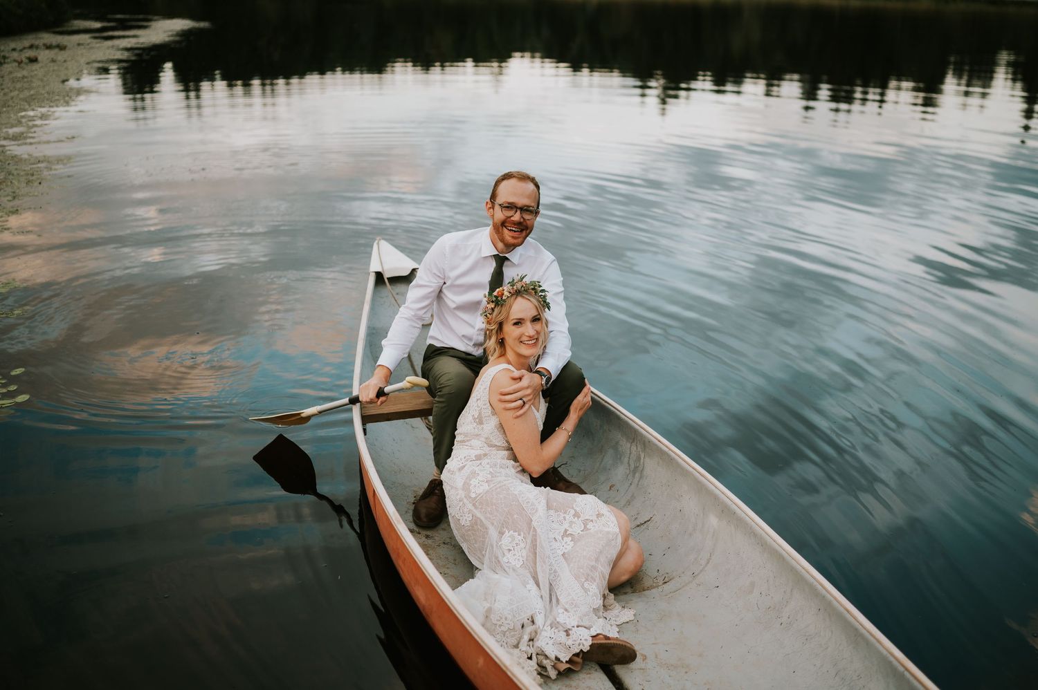 Wedding Couple sitting in Canoe at Smith Lake Farm wedding venue on Vancouver Island. Photography by Photographer Soulfull Photographs