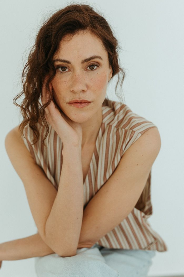 Soft portrait series featuring striped top against white background.
