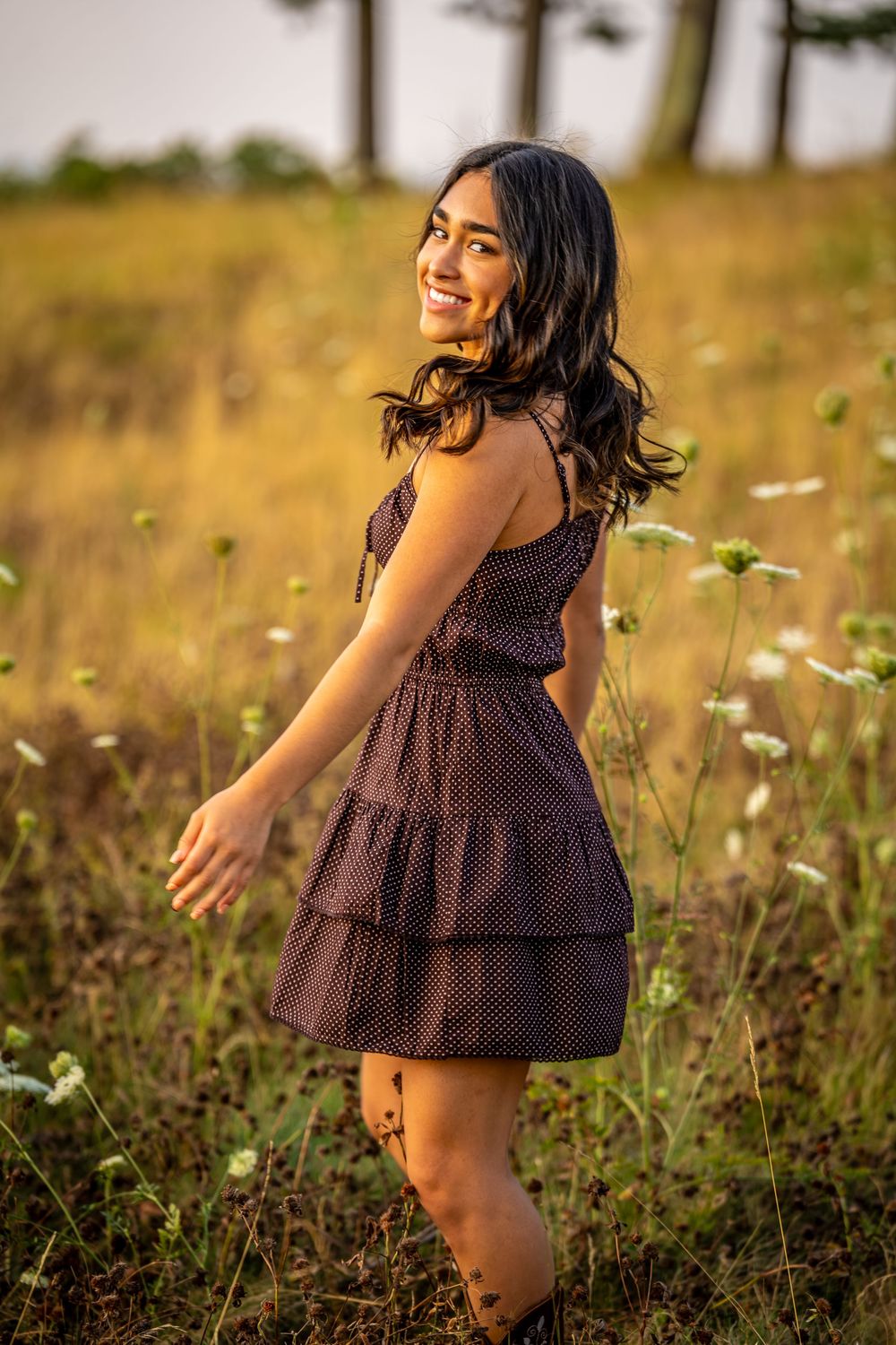 Summer portrait session in a wildflower meadow during golden hour.