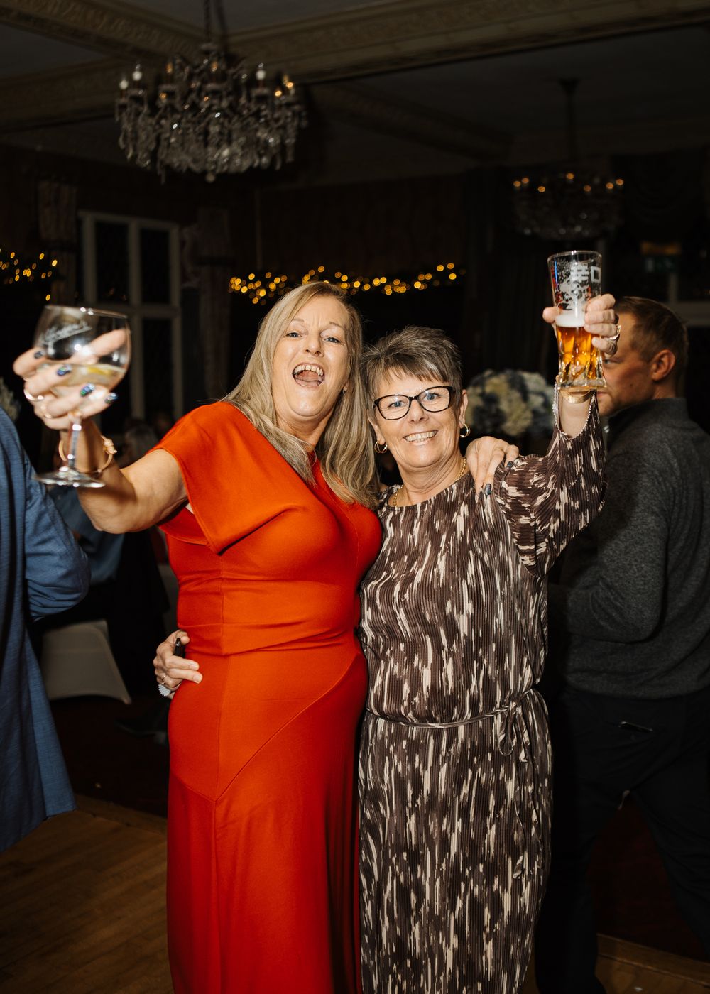 Women hold drinks up on the dance floor at Ye Old Bell, Barnby Moor.