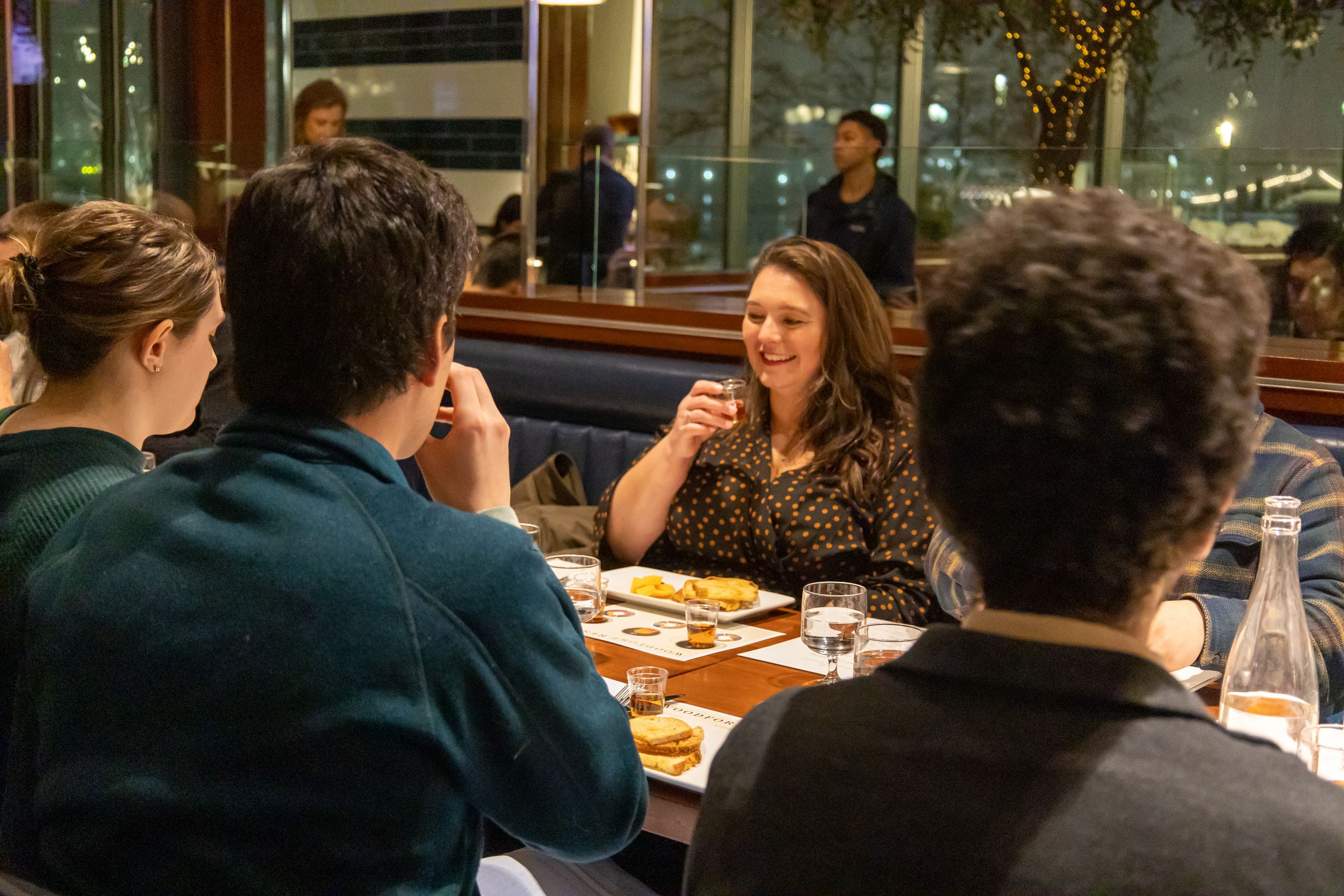 Casual dining scene with guests engaged in lively conversation at a restaurant table.