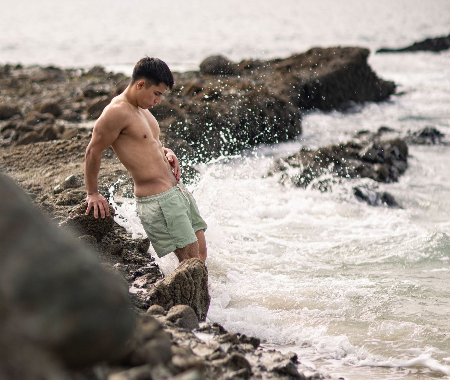 Photograph of shirtless man at the beach by Los Angeles boudoir photographer.
