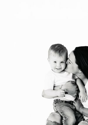 A series of tender black and white photos showing parent and child sharing intimate moments of affection and bonding.