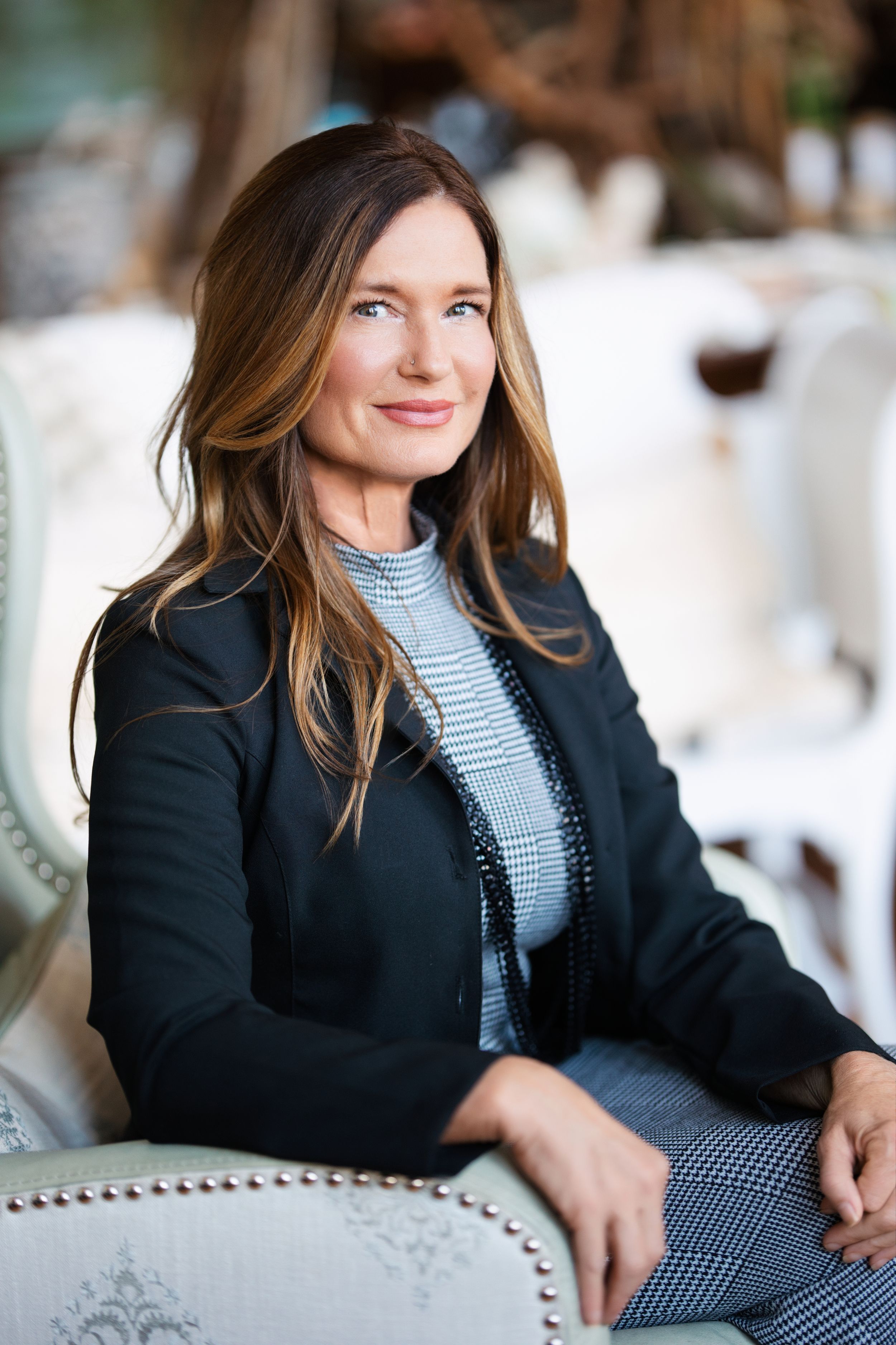 Professional portrait series showing a woman in a black blazer and striped top against a light background. Middle TN branding photographer.