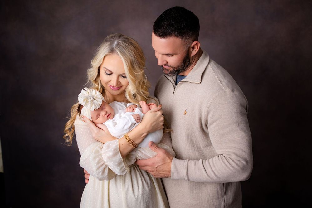 Studio family newborn portrait session with soft lighting against a dark background.  Middle TN newborn photographer.