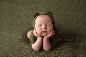 Artistic newborn photography series showing sleeping baby in various peaceful poses on grey backdrop.