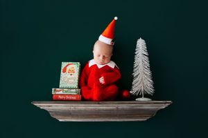 Red and white holiday decorations including a Santa figure and white tree arranged on floating wall shelves.
