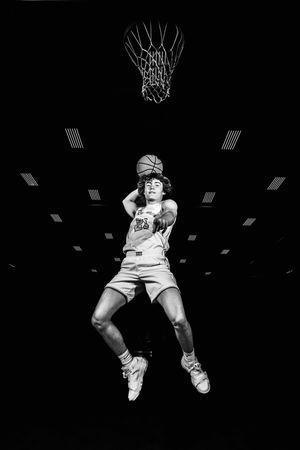 Series of black and white basketball action shots showing a player dunking the ball through a hoop.