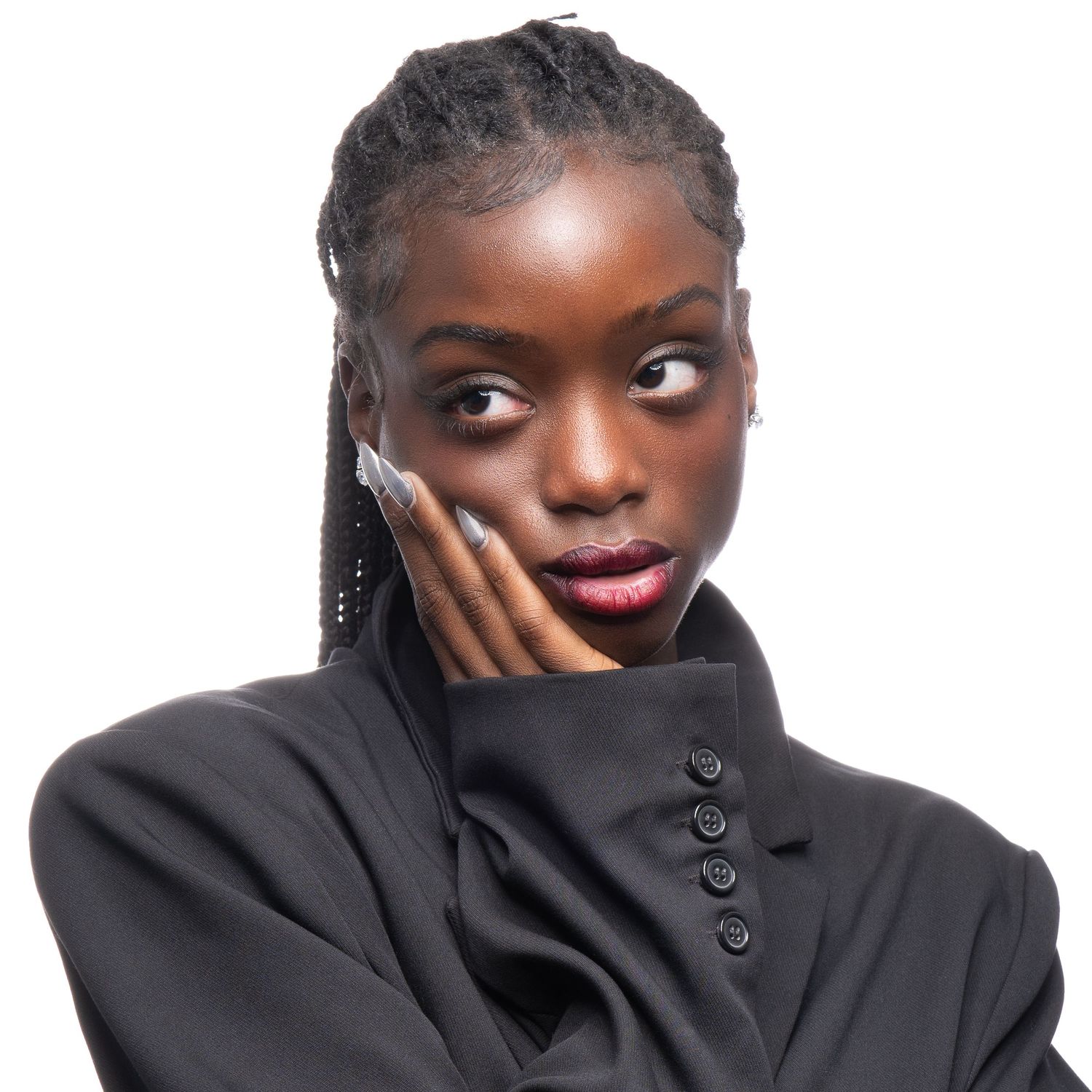 Elegant fashion portrait of model in black turtleneck with hand on cheek.