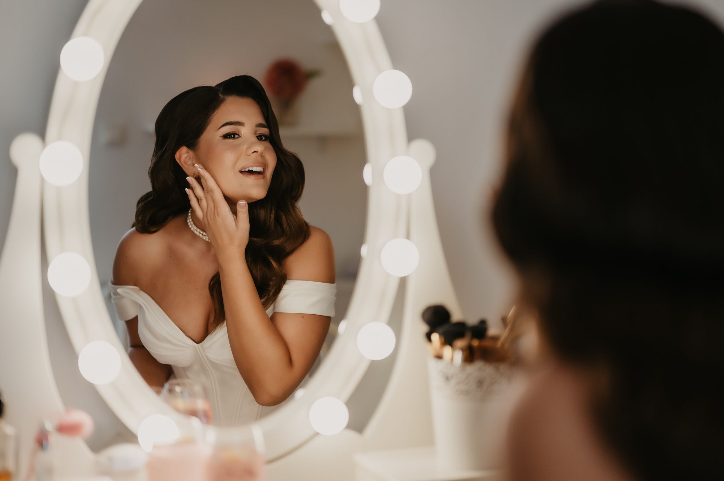 A series of wedding photos showing candid moments of a bride in a white dress and veil during her special day.