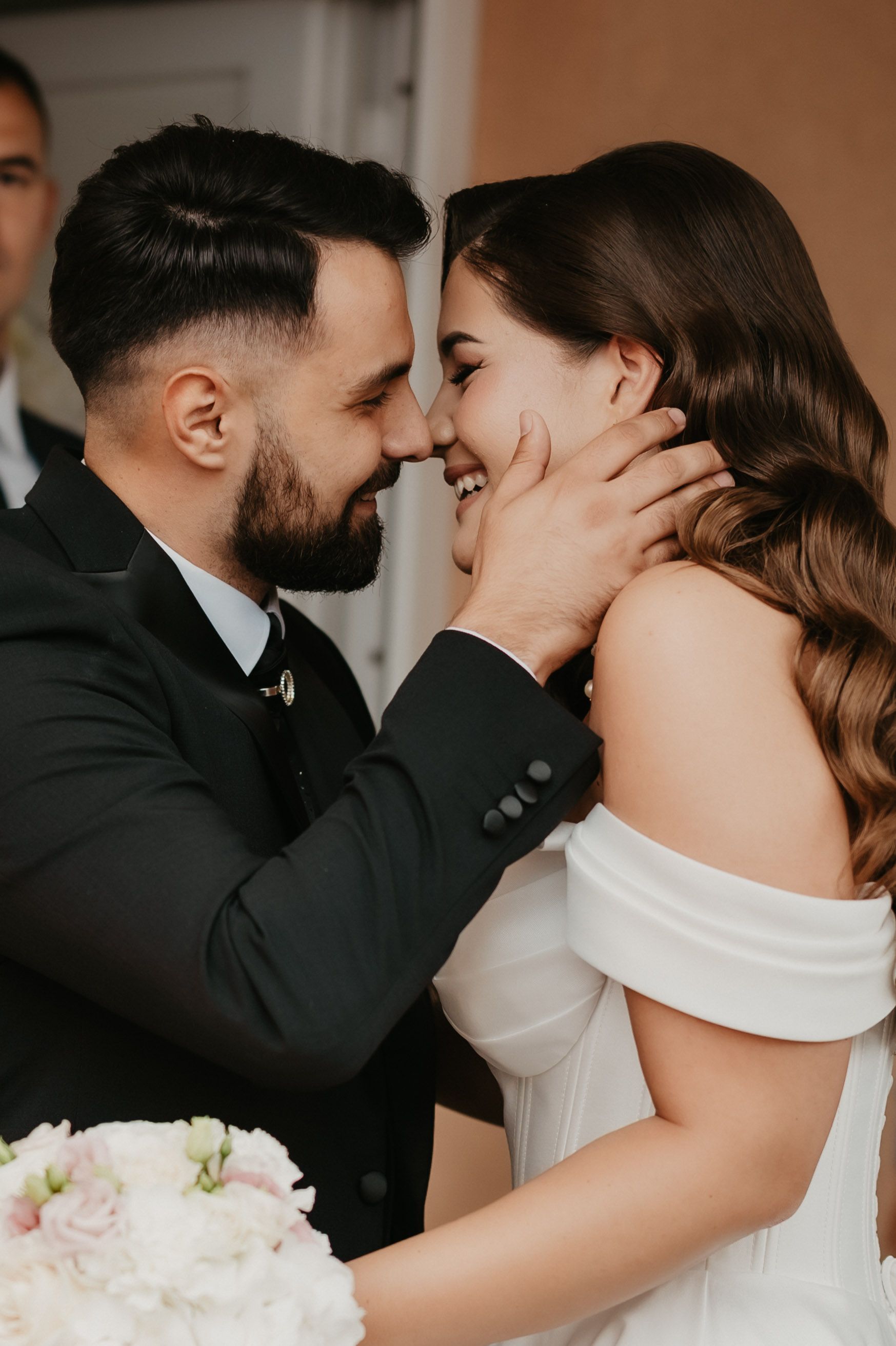 Close-up romantic wedding photos showing tender moments between newlyweds in black and white formal attire.