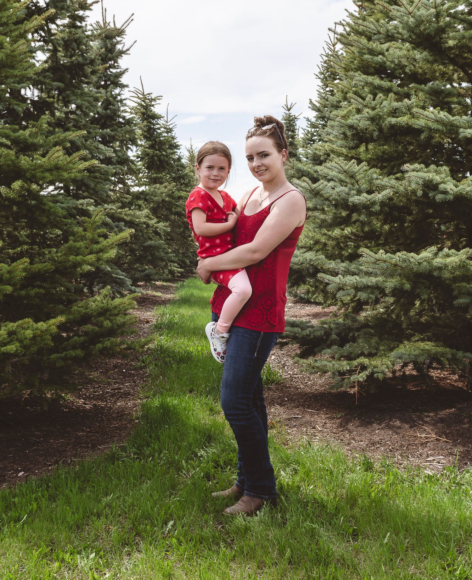 Family portrait among evergreen trees