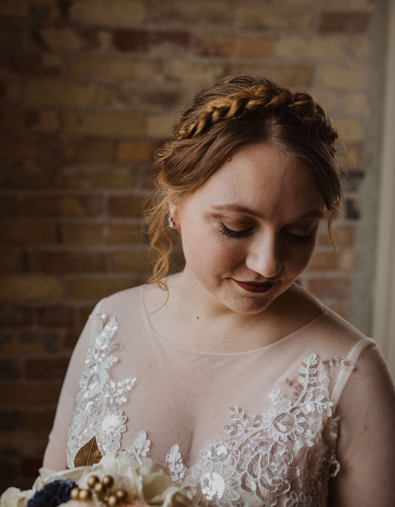 Detailed shot of delicate lace appliques on a wedding dress bodice.