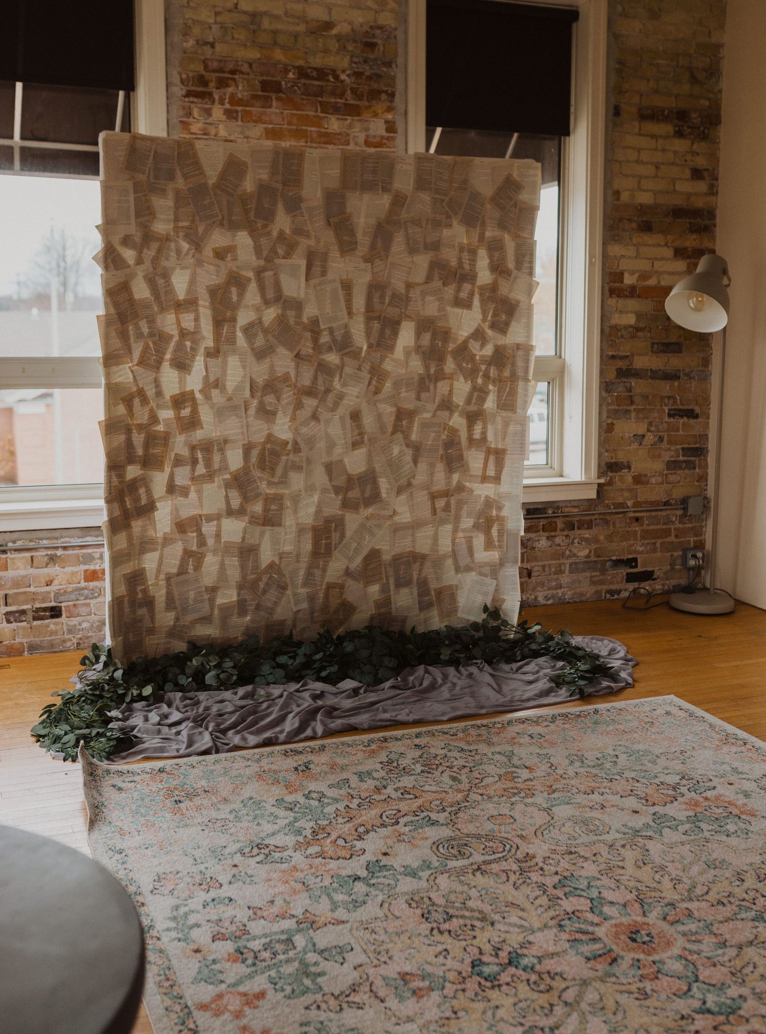 Vintage-style room with exposed brick walls and patterned area rug on hardwood floor.