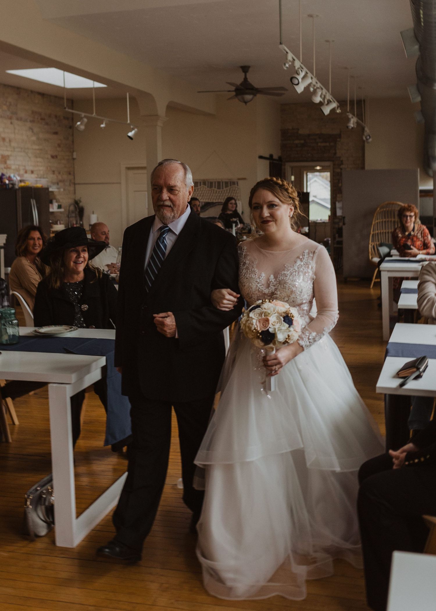 Wedding celebration in an industrial-chic venue with exposed brick and wooden floors.