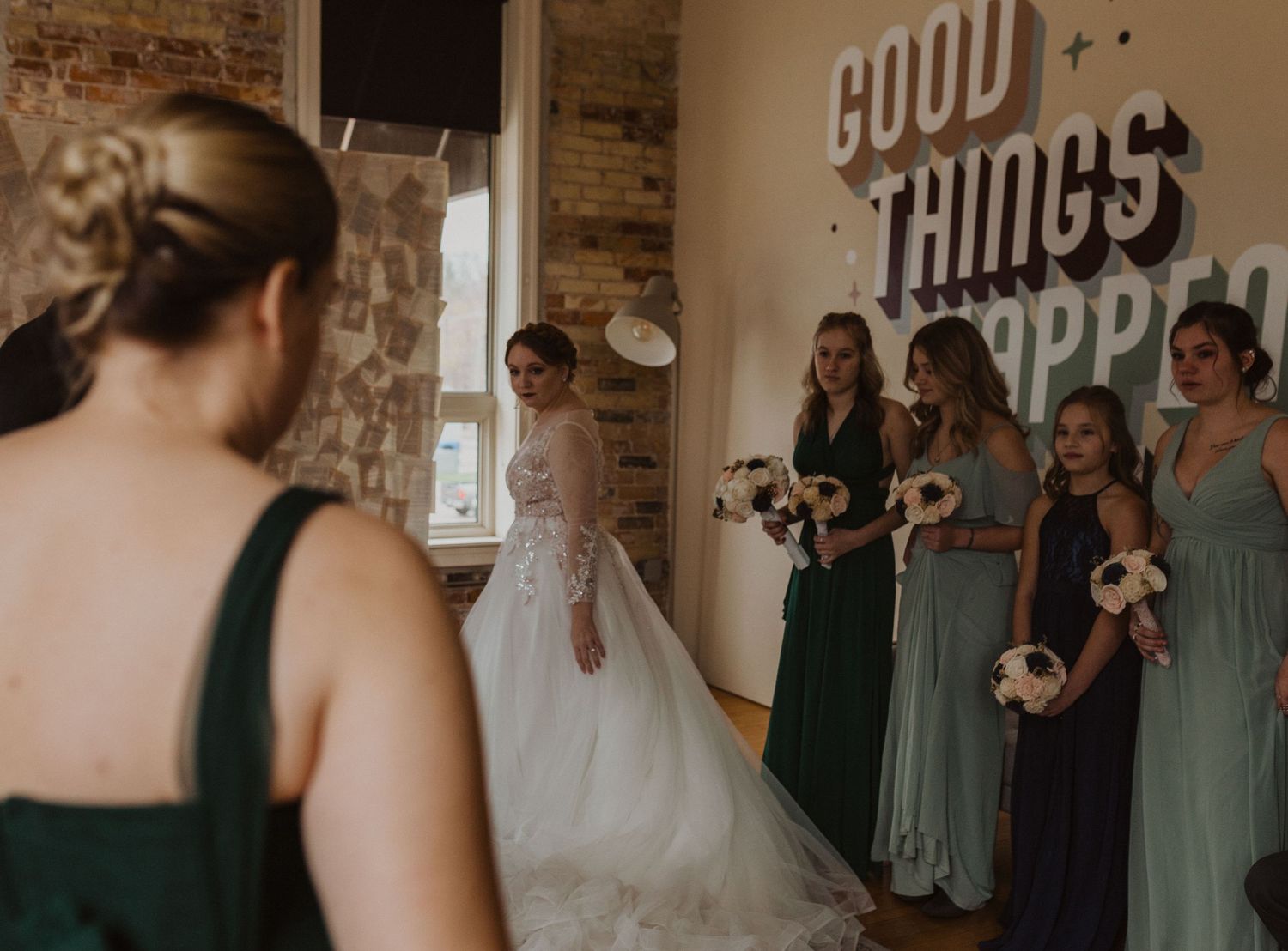 Wedding venue with 'GOOD THINGS' signage and sage green accents.