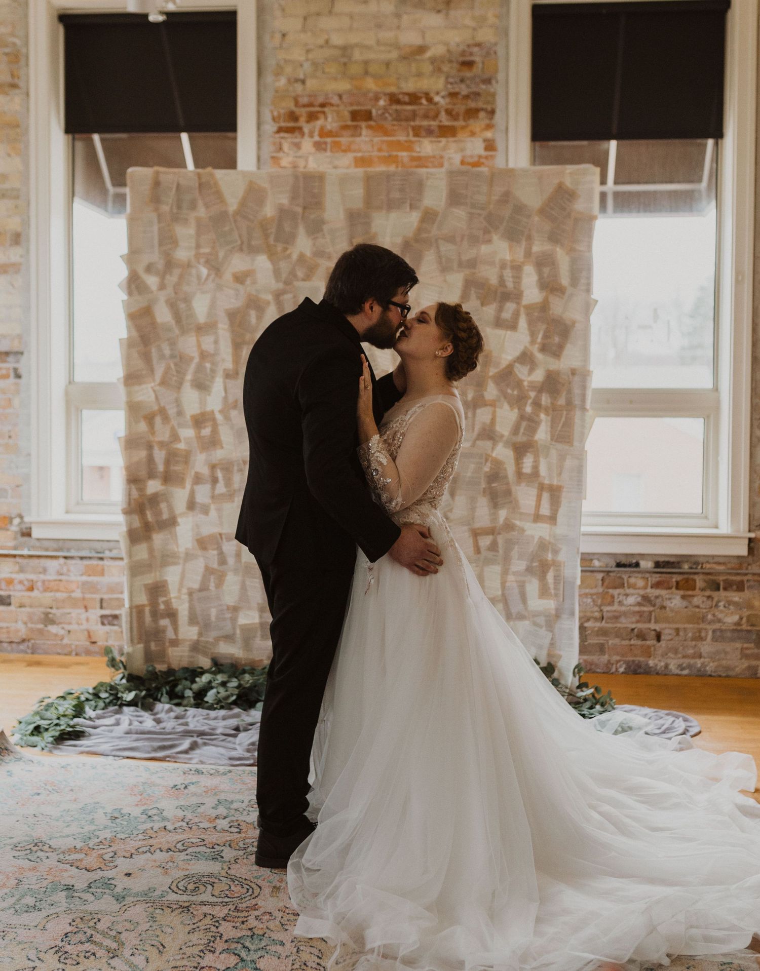 Romantic wedding ceremony moment in a historic brick venue with natural lighting.