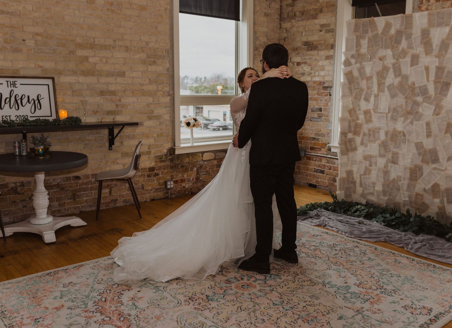 Intimate wedding moments unfold in an industrial-style venue with exposed brick walls.