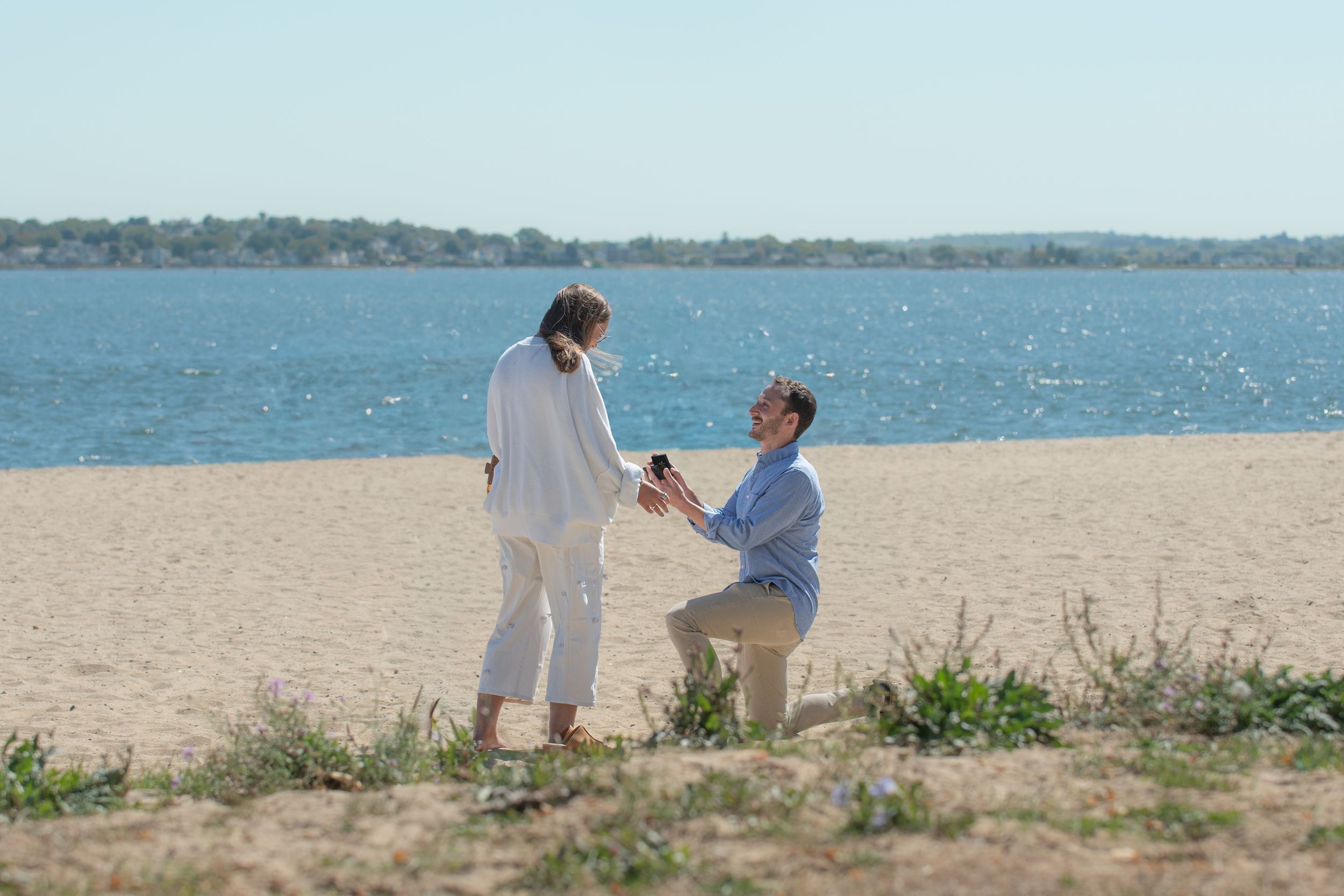 Surprise proposal and couples engagement photos on the M Street beach in Boston, Massachusetts