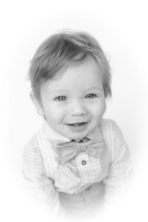 High-key black and white portrait series showing joyful expressions in close-up.