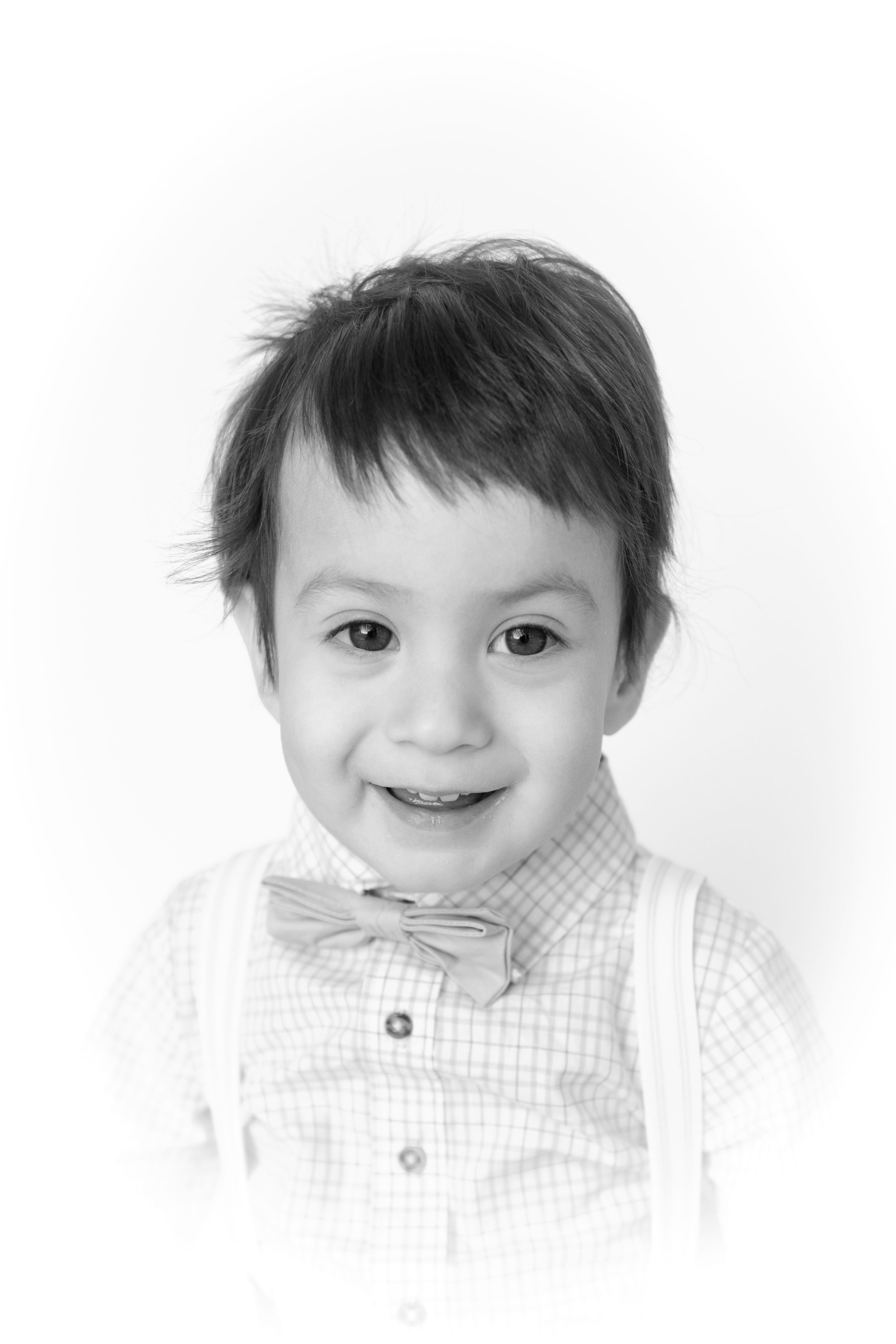 Close-up black and white portrait series showing cheerful expressions and a checkered shirt.