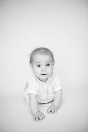 Black and white series showing infant expressions and movements on white background.