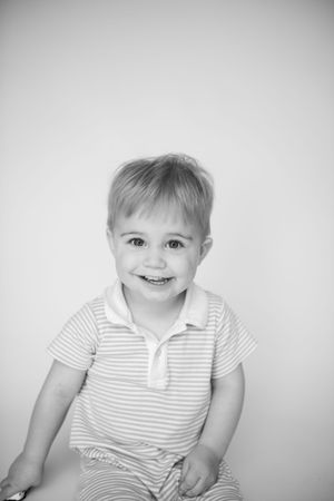 Portrait series showing a young child in striped shirt against white backdrop.