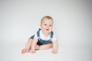 Series of black and white portraits showing an infant against white background.