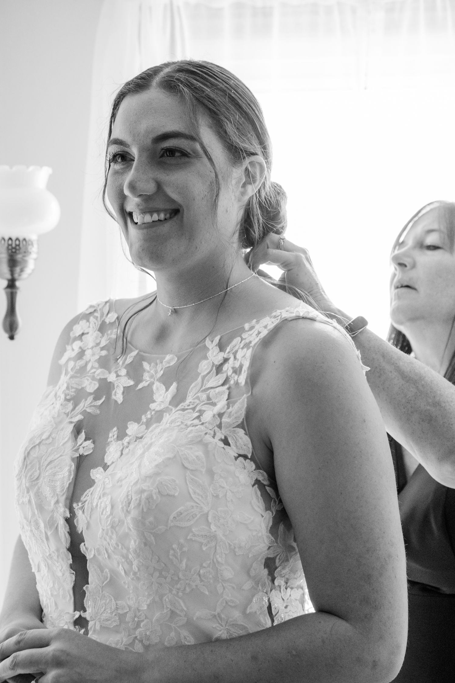 Wedding dress preparation scene with delicate lace details and natural lighting.