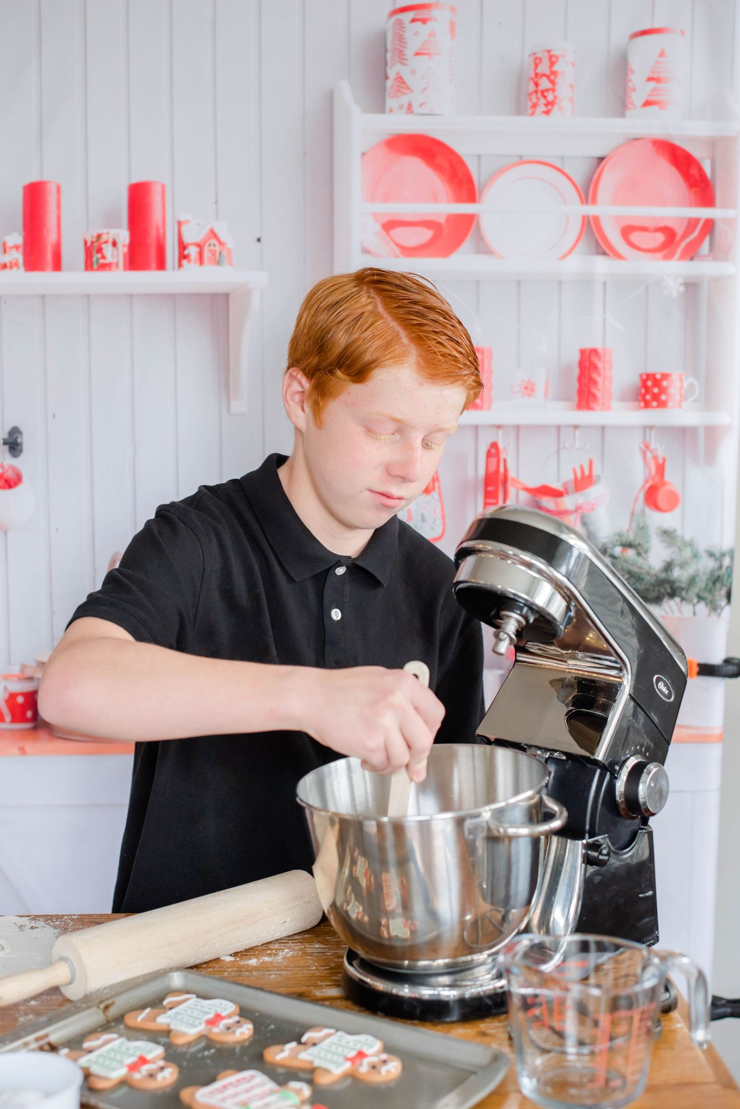 Using a stand mixer to prepare cookie dough in a modern kitchen with white and red accents.