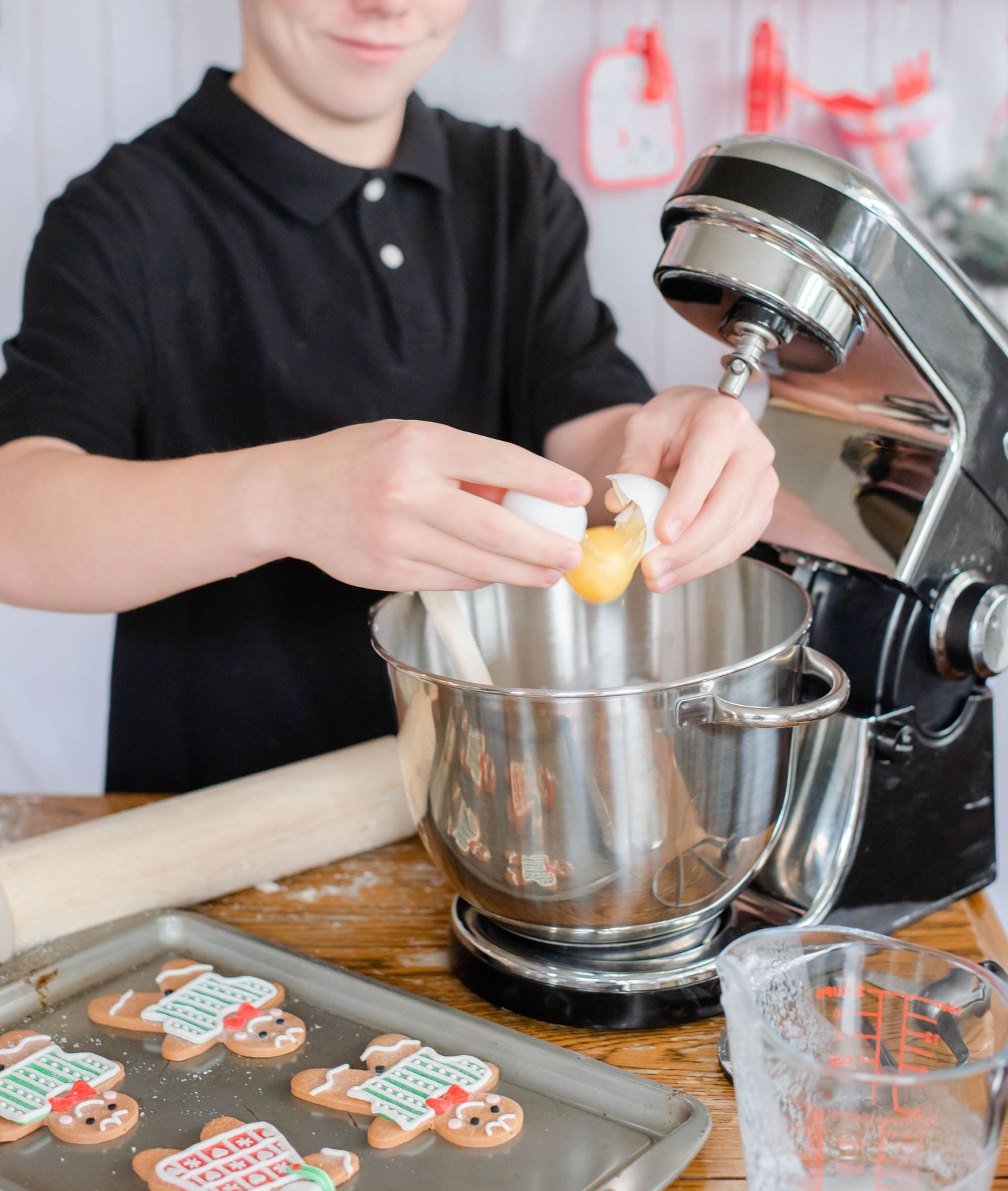 Baking scene showing cookie cutting and dough preparation on a wooden surface.