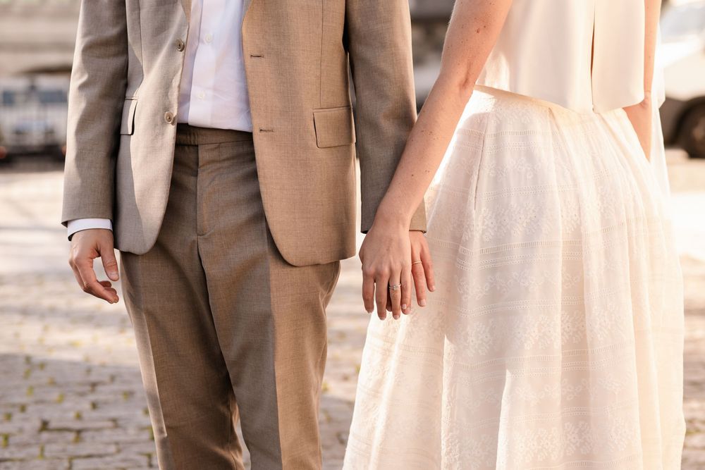 Close ups of bride and groom holding hands during destination wedding in Paris, France.