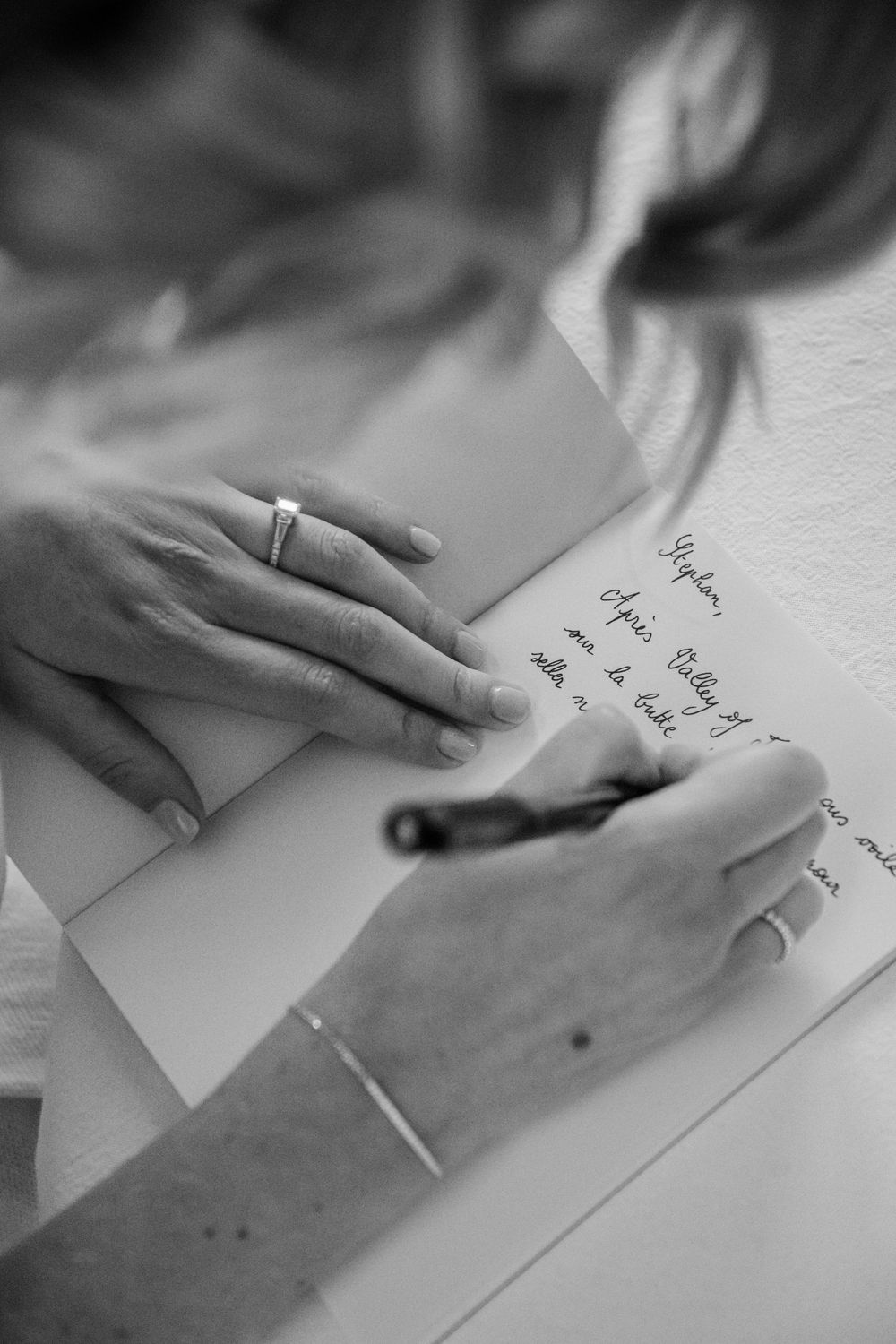 Close up of bride writing her vows during destination wedding in Paris, France.