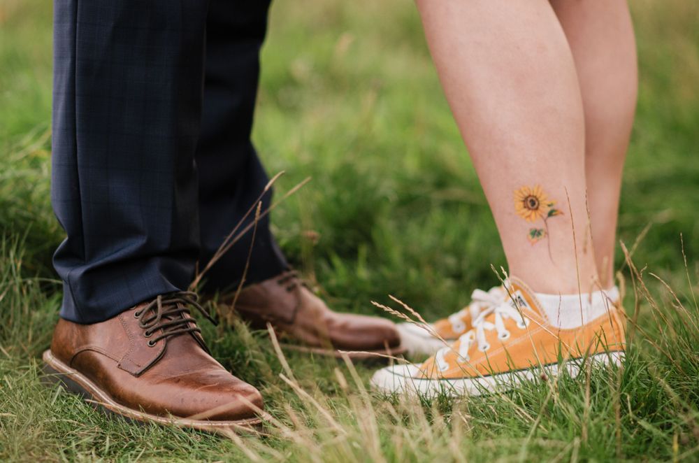 Close up of feet and tattoo during engagement shoot in Scottish countryside.