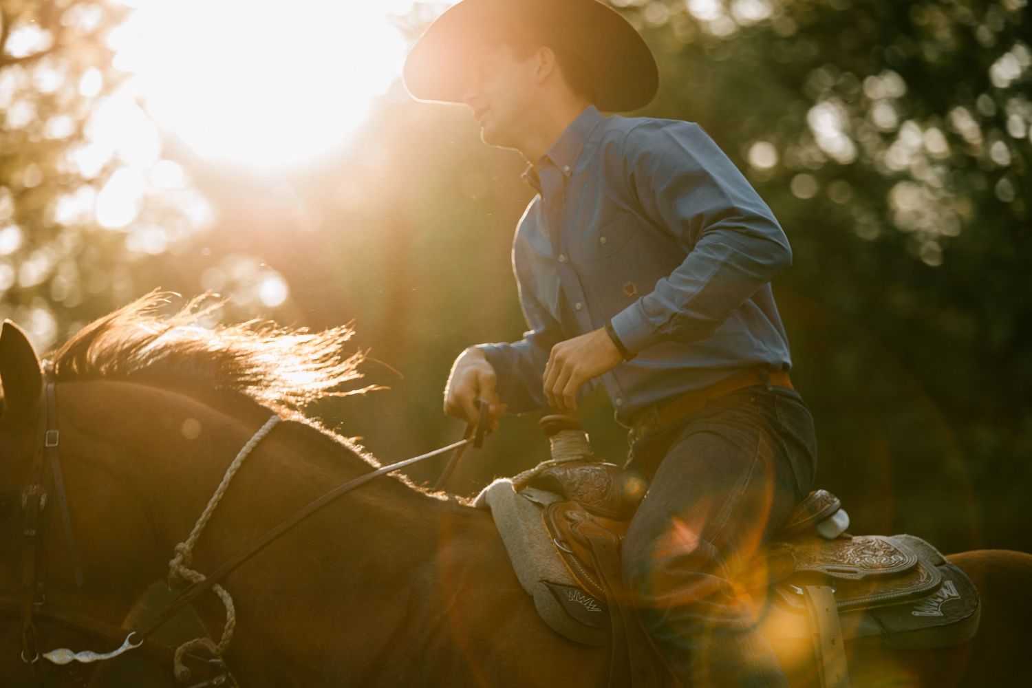 Senior photos of a cowboy on his horse running in Ada, Oklahoma.