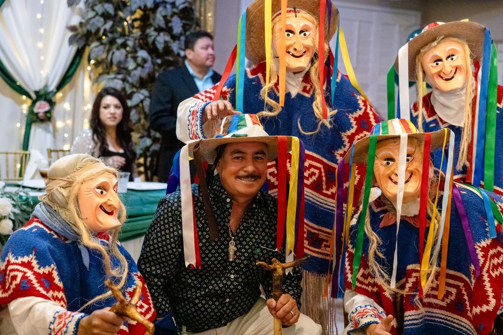 Colorful folk art puppets and decorations displayed at an indoor celebration.
