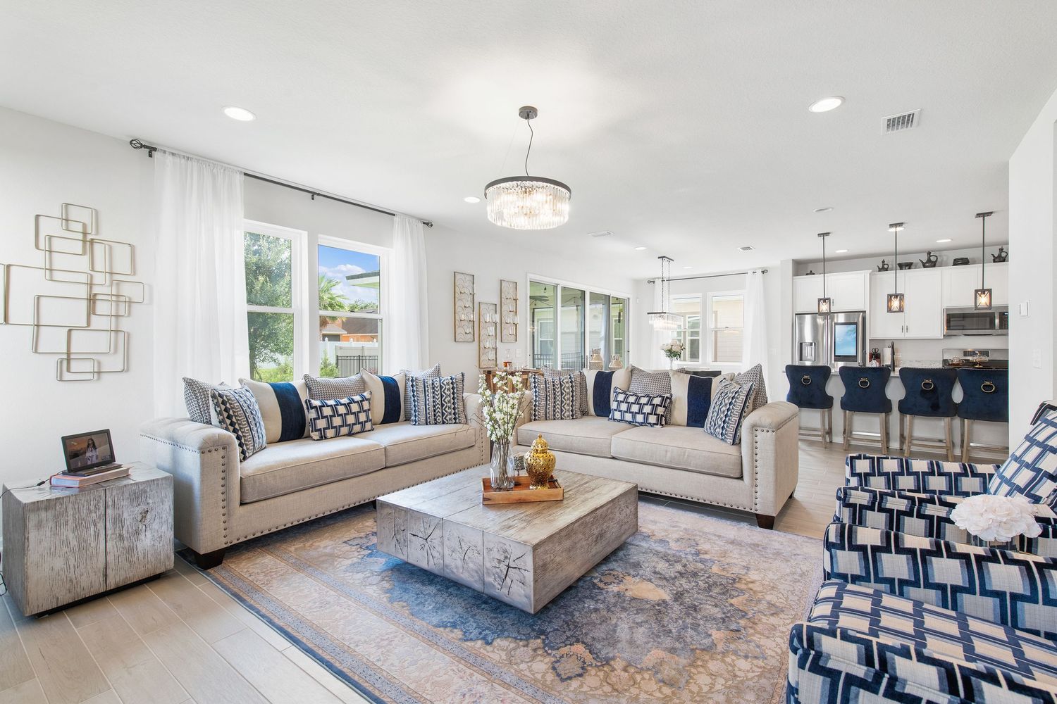 Bright living room with sectional sofas, decorative pillows, and modern lighting fixtures in Florida.