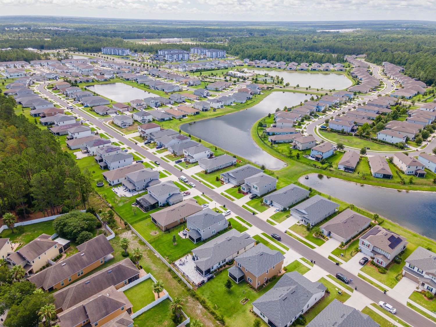 Aerial view of planned residential community with houses and waterways in Jacksonville, Florida.