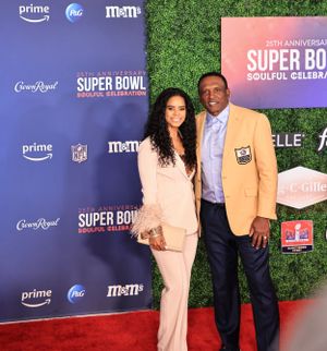 A couple poses together on the red carpet at the NFL Super Bowl Soulful Celebration.