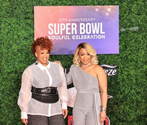 Attendees pose on the red carpet at the 25th Anniversary Super Bowl Soulful Celebration event.