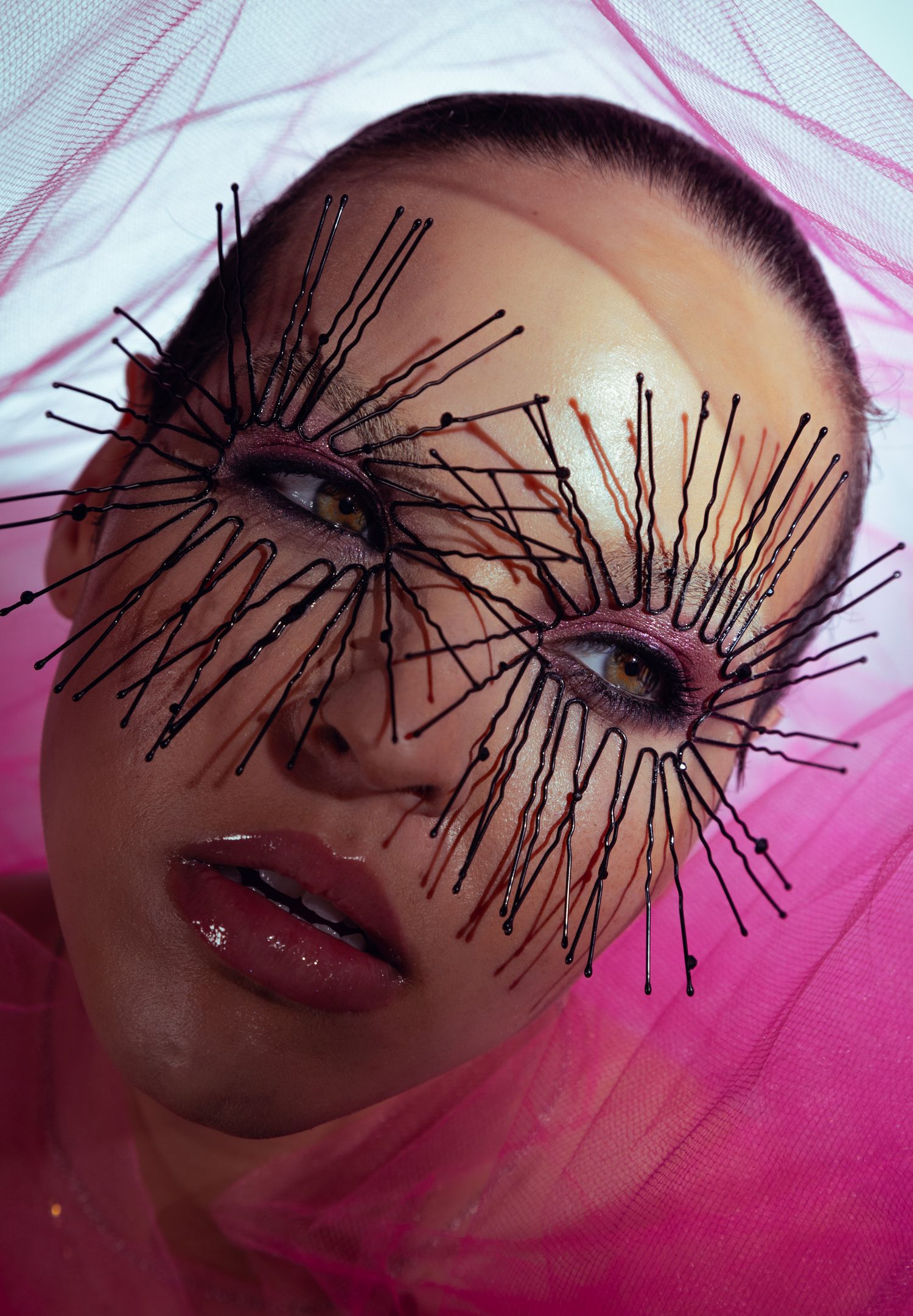 Artistic beauty portrait with dramatic black lines creating geometric patterns on face.