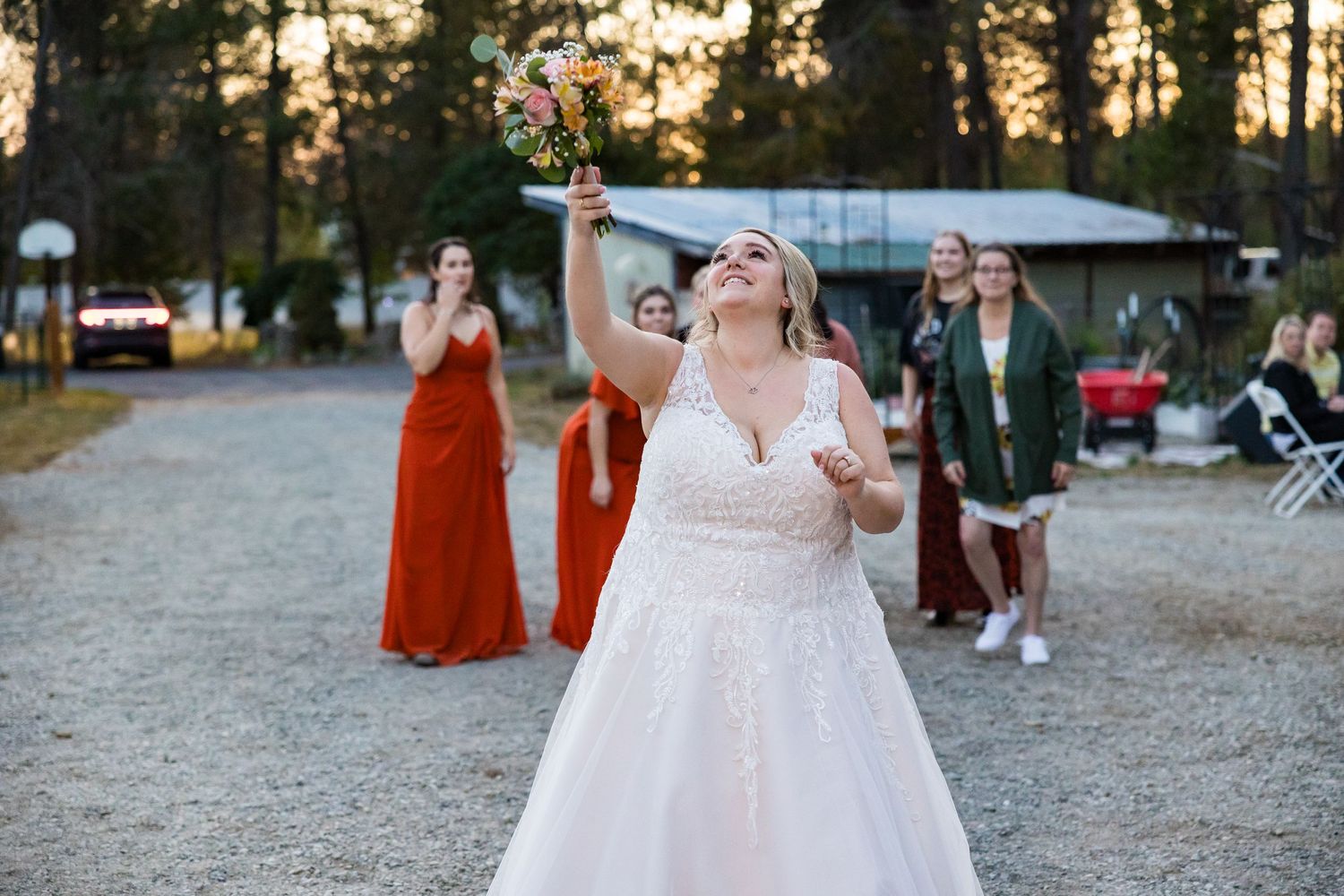 Celebratory moment captured at an outdoor wedding with guests in formal attire.