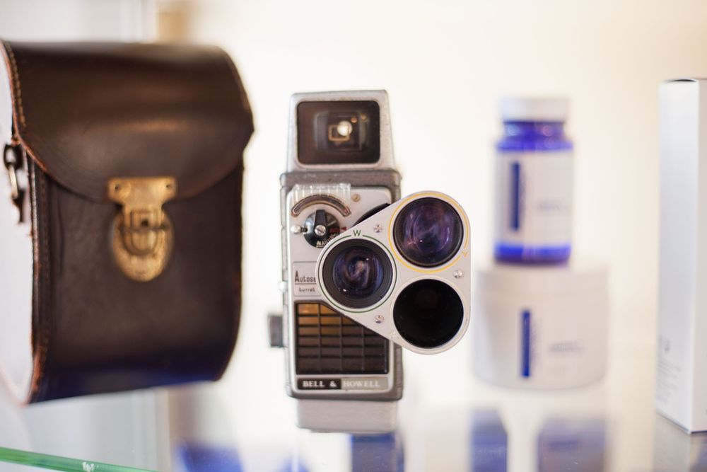 Old style camera with soft background diffusing the items on a shelf.