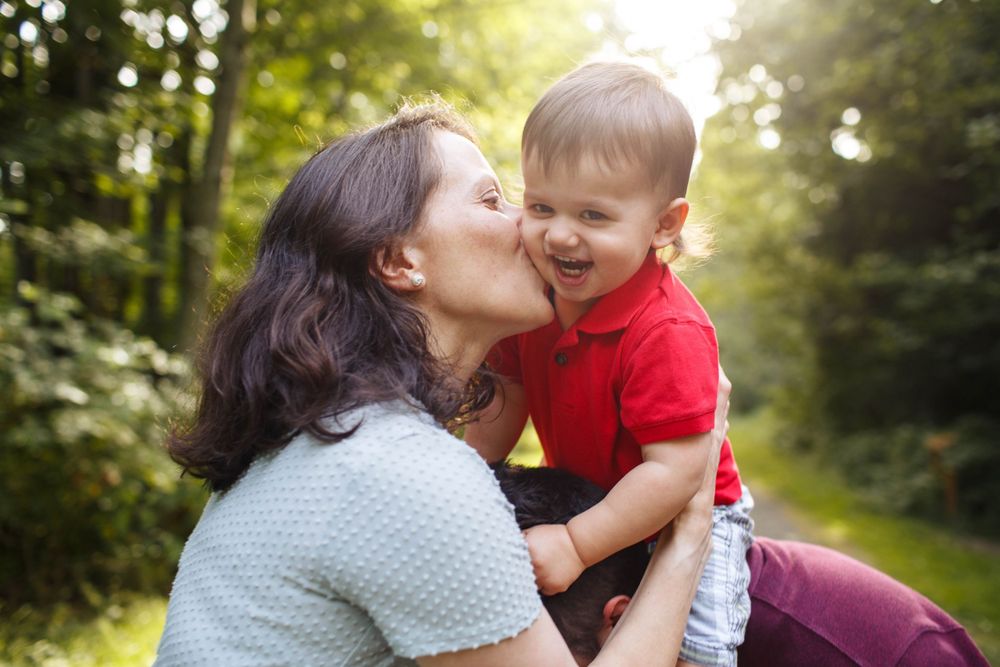 Snohomish family photographer: A mother kisses the cheek of her toddler at Willis Tucker Park in Snohomish WA