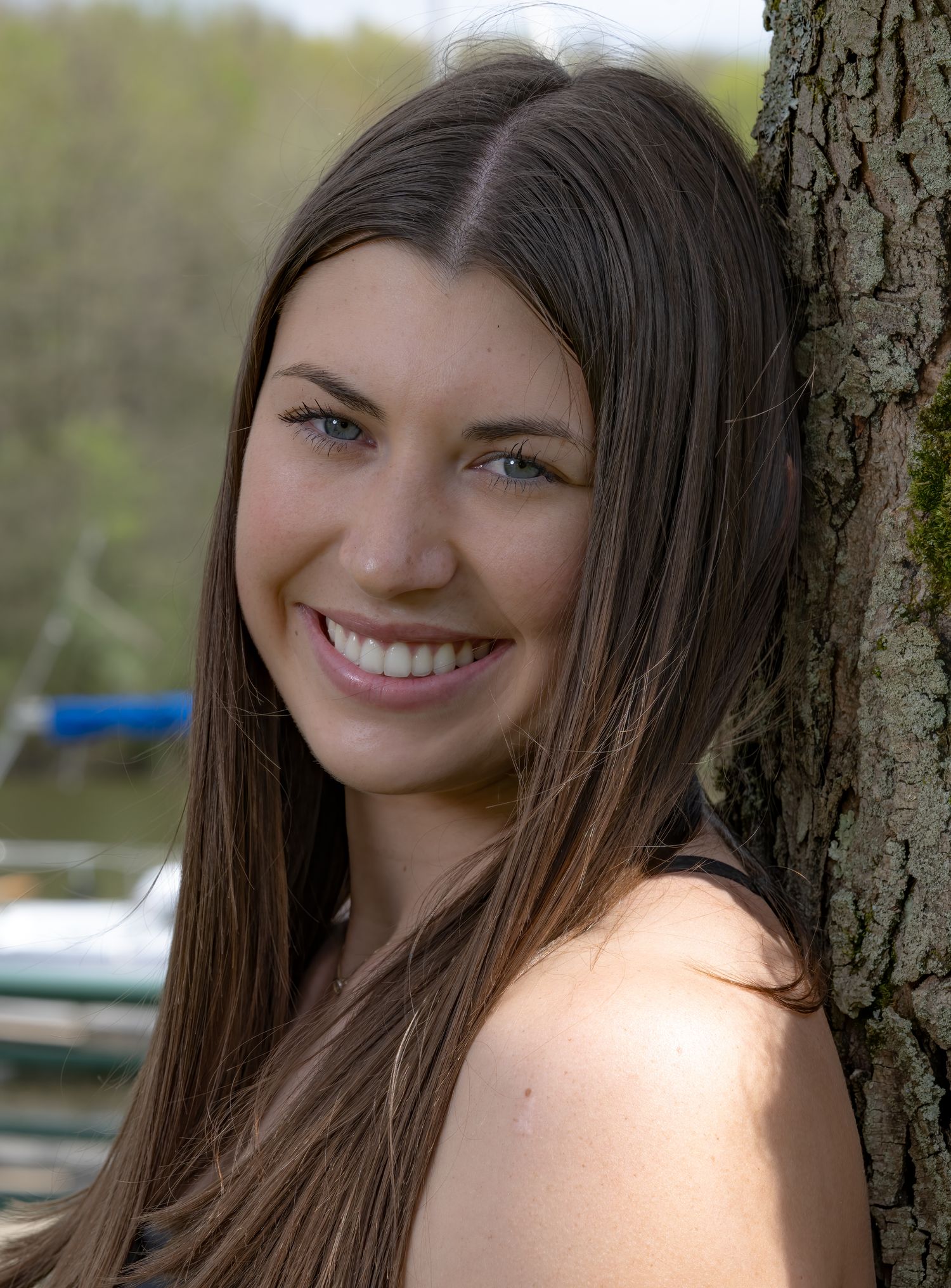 Portrait series showing person with long brown hair against natural outdoor background.