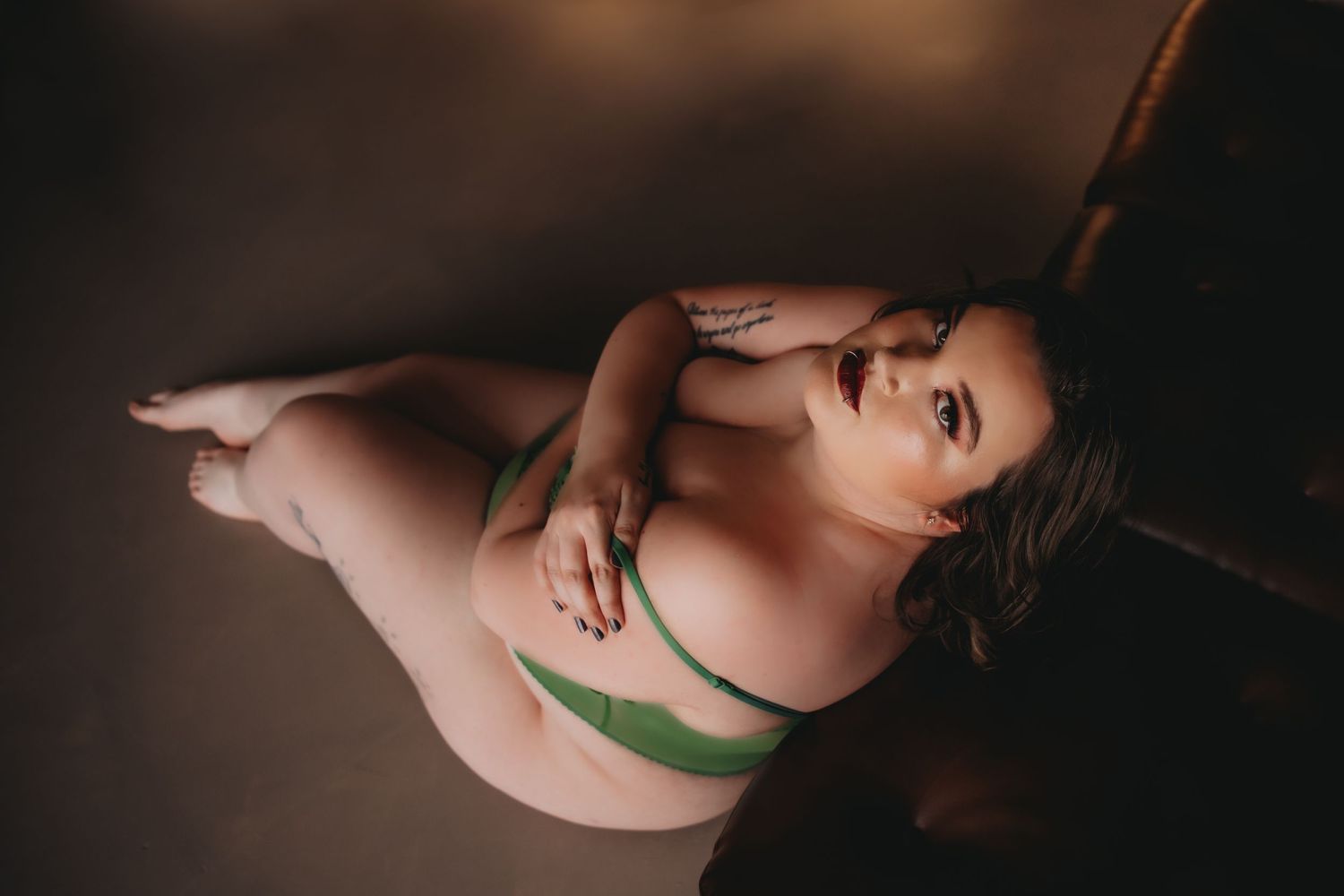 woman in green lingerie on a brown couch