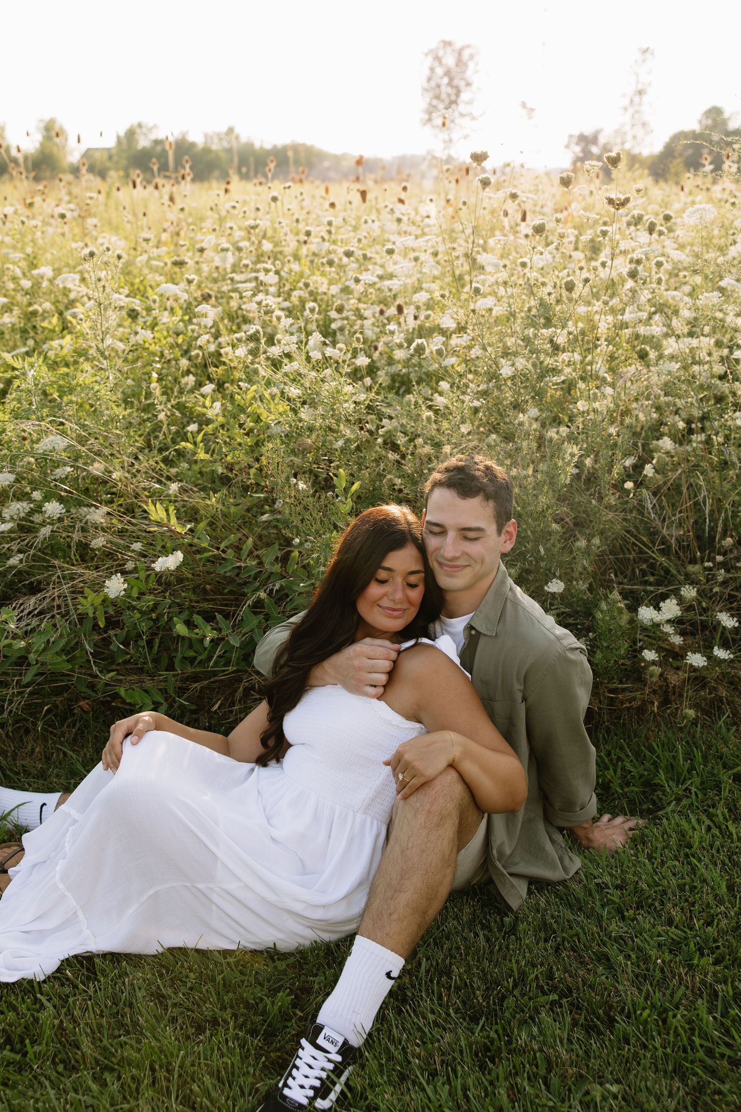 A romantic sunset moment captured in a wildflower meadow during a golden hour photoshoot.