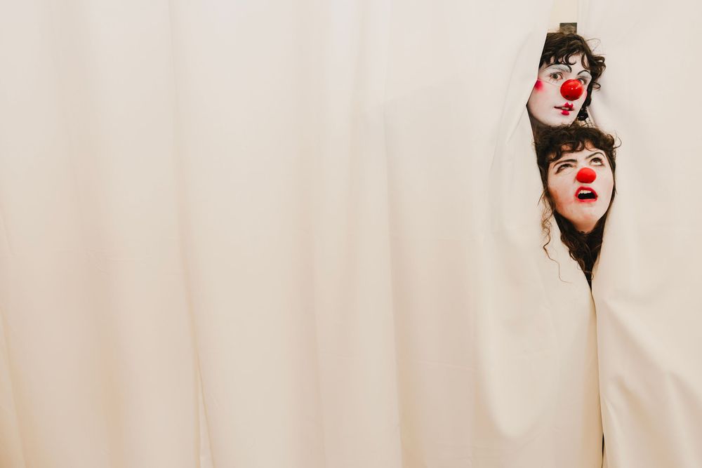 A series of photos showing someone wearing a red clown nose and making playful expressions.